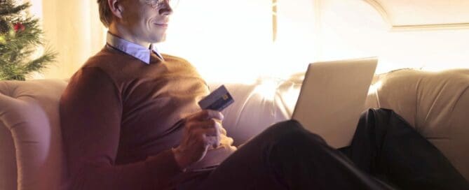 man sitting on couch purchasing on amazon